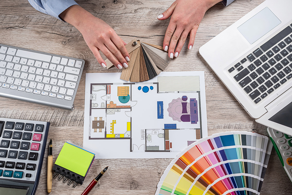 Female designer creative working choose colors for coming repairs home and sketch plan blue print. A Architect renovation concept